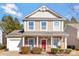 Two-story house with stone accents, attached garage, and a red front door at 4152 Broadstairs Sw Dr, Concord, NC 28025