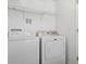 Functional laundry room with washer, dryer, and overhead shelving at 4152 Broadstairs Sw Dr, Concord, NC 28025