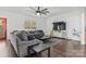 Relaxing living room with sectional sofa, large TV, and hardwood floors at 4152 Broadstairs Sw Dr, Concord, NC 28025