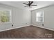 Spacious bedroom with two windows, wood-look flooring, and ceiling fan at 4532 Oakwood Cir, Gastonia, NC 28056