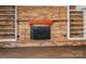 Brick fireplace with a decorative screen and wooden mantel at 4532 Oakwood Cir, Gastonia, NC 28056