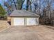 Two-car detached garage with white doors and grey asphalt driveway at 4532 Oakwood Cir, Gastonia, NC 28056