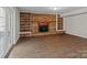 Gathering room featuring a brick fireplace, built-in shelving, and hardwood floors at 4532 Oakwood Cir, Gastonia, NC 28056