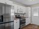 Modern kitchen with stainless steel appliances and white cabinets at 4532 Oakwood Cir, Gastonia, NC 28056