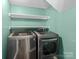 Laundry room with LG washer and dryer and white shelves at 4532 Oakwood Cir, Gastonia, NC 28056