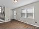 Bright living room with hardwood floors, neutral walls, and a view of the staircase at 4532 Oakwood Cir, Gastonia, NC 28056