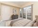 Bedroom with sliding doors to balcony, and city views at 4620 Piedmont Row Dr # 318D, Charlotte, NC 28210