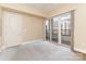 Bedroom with sliding door to balcony and city views at 4620 Piedmont Row Dr # 318D, Charlotte, NC 28210