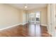 Spacious bedroom featuring hardwood floors and access to a private balcony at 4620 Piedmont Row Dr # 318D, Charlotte, NC 28210