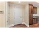 Bright entryway with hardwood floors and kitchen pantry at 4620 Piedmont Row Dr # 318D, Charlotte, NC 28210