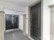 Modern entryway with dark door and access to building's interior at 4620 Piedmont Row Dr # 318D, Charlotte, NC 28210