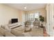 Bright living room with hardwood floors, balcony access, and modern furniture at 4620 Piedmont Row Dr # 318D, Charlotte, NC 28210