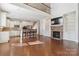 Open living area with stone fireplace, built-in shelving, and hardwood floors at 4855 Star Hill Ln, Charlotte, NC 28214