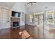 Living room with fireplace, built-in shelving, and hardwood floors at 4855 Star Hill Ln, Charlotte, NC 28214