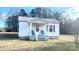 Charming white cottage featuring a front porch and well-manicured lawn at 510 W Blume St, Landis, NC 28088