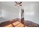 Sunlit bedroom featuring hardwood floors, a ceiling fan and a staircase in view at 544 New Bern Station Ct, Charlotte, NC 28209