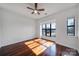 Bright bedroom featuring a ceiling fan, large windows, and hardwood floors at 544 New Bern Station Ct, Charlotte, NC 28209