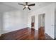 Inviting bedroom featuring hardwood floors, a ceiling fan, and doorways to the bathroom and hallway at 544 New Bern Station Ct, Charlotte, NC 28209