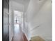 Bright hallway with hardwood floors leading to a bedroom with a ceiling fan and natural light at 544 New Bern Station Ct, Charlotte, NC 28209