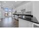 Open kitchen featuring modern stainless steel appliances, black countertops, and ample white cabinets at 544 New Bern Station Ct, Charlotte, NC 28209