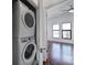 Conveniently located laundry area with a stacked washer and dryer, adjacent to a bright bedroom at 544 New Bern Station Ct, Charlotte, NC 28209