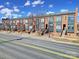 Street view of modern townhomes with brick and siding facades, each with individual entries at 544 New Bern Station Ct, Charlotte, NC 28209