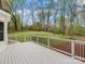 Inviting back deck overlooking a sprawling yard, featuring a white railing and serene natural views at 5972 Rathlin Nw Ct, Concord, NC 28027