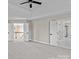 Spacious bedroom with ceiling fan and access to upper hallway at 5972 Rathlin Nw Ct, Concord, NC 28027