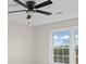 Bright bedroom with ceiling fan and window views at 5972 Rathlin Nw Ct, Concord, NC 28027