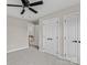 Cozy bedroom featuring plush carpeting, ceiling fan, and an open doorway to an adjoining room or hallway at 5972 Rathlin Nw Ct, Concord, NC 28027