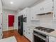 Kitchen with white cabinets, granite counters and black appliances at 5972 Rathlin Nw Ct, Concord, NC 28027