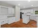 White kitchen with island and stainless steel appliances at 5972 Rathlin Nw Ct, Concord, NC 28027