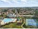 Beautiful aerial view of the neighborhood clubhouse, pool, playground, and tennis courts in a suburban setting at 6007 Cadence Ln, Indian Land, SC 29707