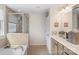 Light-filled bathroom featuring a soaking tub and glass-enclosed shower at 6007 Cadence Ln, Indian Land, SC 29707