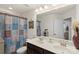 Charming bathroom featuring double sinks, decorative shower curtain, and a large mirror, enhancing functionality and aesthetics at 6007 Cadence Ln, Indian Land, SC 29707