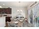 Bright dining room featuring a modern chandelier and sliding glass door, complemented by stylish decor at 6007 Cadence Ln, Indian Land, SC 29707