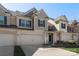 Attractive townhome featuring a two-car garage, well-kept lawn, and inviting entrance on a sunny day at 6007 Cadence Ln, Indian Land, SC 29707