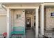 Welcoming front porch with a bench and seasonal wreath, complemented by brick and stone accents at 6007 Cadence Ln, Indian Land, SC 29707