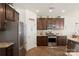 Spacious kitchen featuring stainless steel appliances, dark wood cabinetry, and hardwood floors at 6007 Cadence Ln, Indian Land, SC 29707