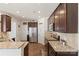 Open kitchen layout with granite countertops, stainless steel appliances, and hardwood floors at 6007 Cadence Ln, Indian Land, SC 29707