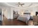 Large main bedroom with hardwood floors, tray ceiling, and ceiling fan at 6007 Cadence Ln, Indian Land, SC 29707