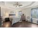 Spacious main bedroom featuring a tray ceiling, ceiling fan and hardwood floors at 6007 Cadence Ln, Indian Land, SC 29707