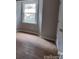 Bright bedroom with large window and hardwood floors at 6106 Meadow Rose Ln, Charlotte, NC 28215