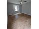 Bright bedroom featuring hardwood floors and a window at 6106 Meadow Rose Ln, Charlotte, NC 28215