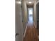 Long hallway with light walls and wood flooring at 6106 Meadow Rose Ln, Charlotte, NC 28215