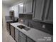 Updated kitchen featuring stainless steel appliances and gray cabinets at 6106 Meadow Rose Ln, Charlotte, NC 28215