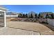 Landscaped backyard featuring a brick paver patio, retaining wall, and view of the lawn at 6503 Georgia Oak Rd, Charlotte, NC 28269