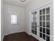 Bright entryway featuring dark hardwood floors and french doors to an office at 6503 Georgia Oak Rd, Charlotte, NC 28269