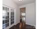 Open hallway with hardwood floors leading to the kitchen and living room at 6503 Georgia Oak Rd, Charlotte, NC 28269