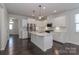 Spacious modern kitchen featuring stainless steel appliances, center island, and plenty of white cabinet storage at 6503 Georgia Oak Rd, Charlotte, NC 28269